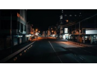 夜晚的街頭，曾經的車水馬龍已不復存在，只剩下孤零零的路燈和寂靜的建筑